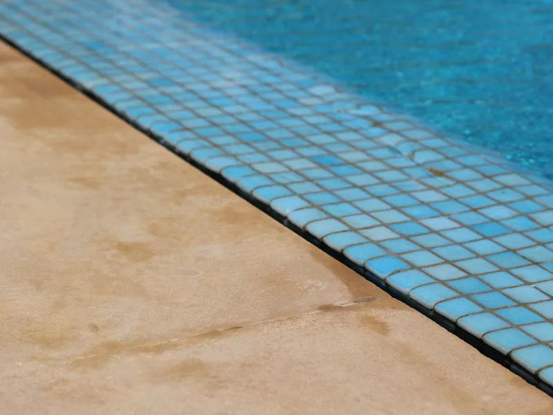 Blue waterline tile and coping edge on a residential pool near Escondido